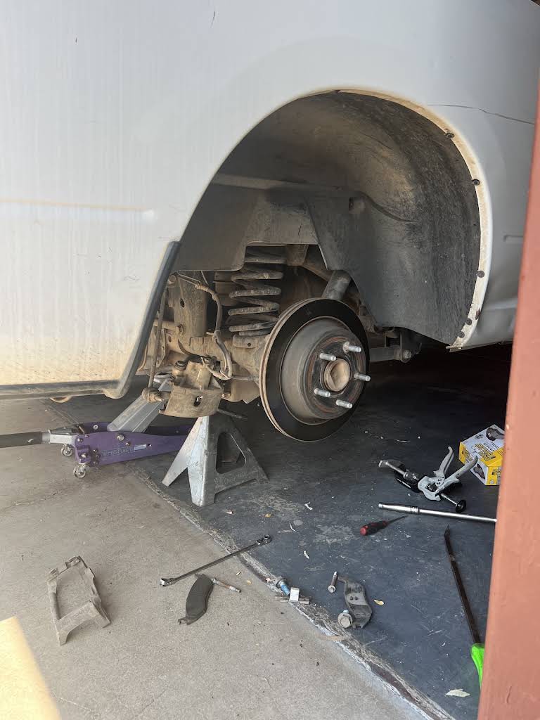 Vehicle raised safely with wheel removed for brake work